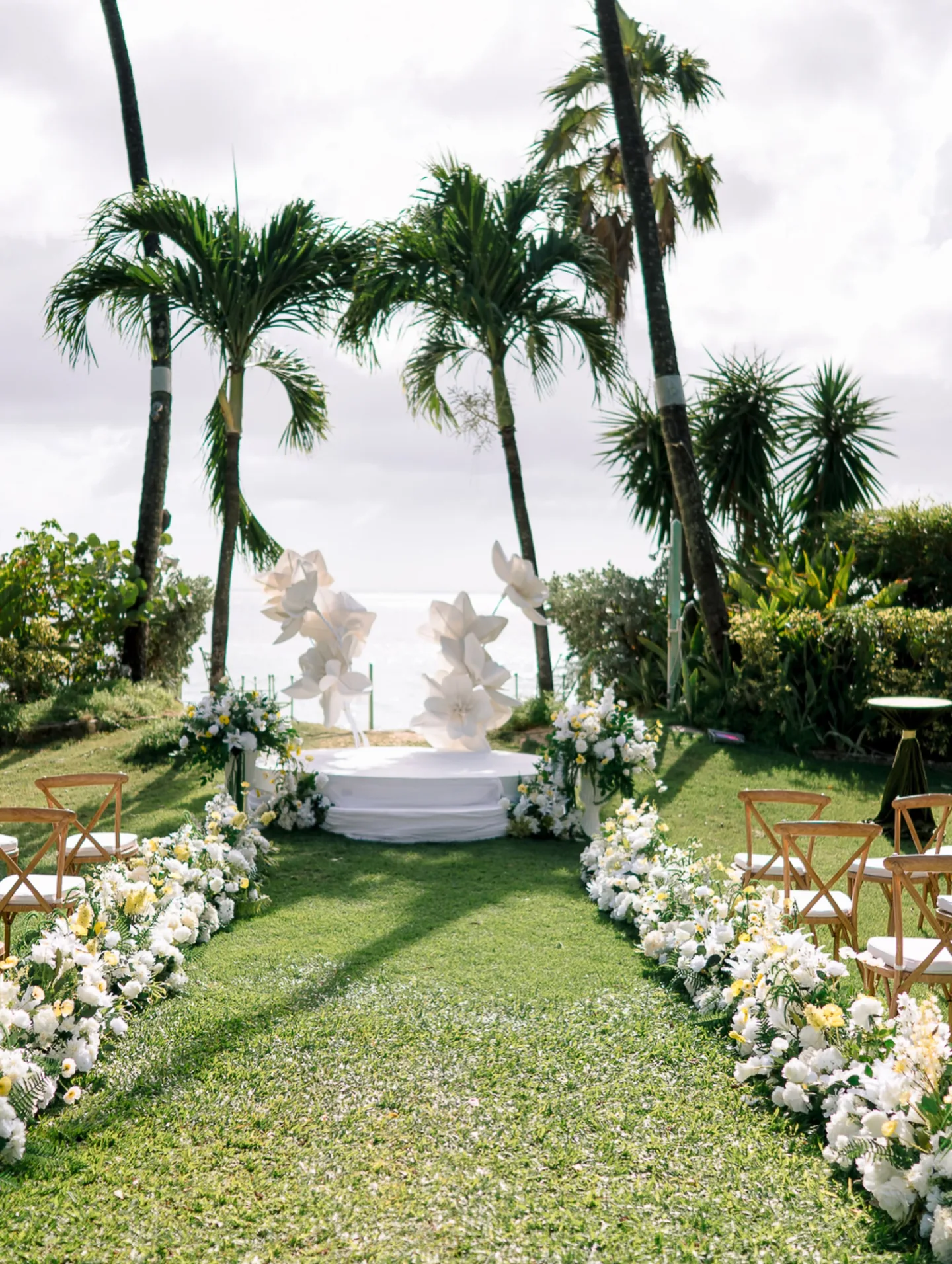 White and yellow wedding ceremony flowers in Barbados from the Destination Florals wedding brochure